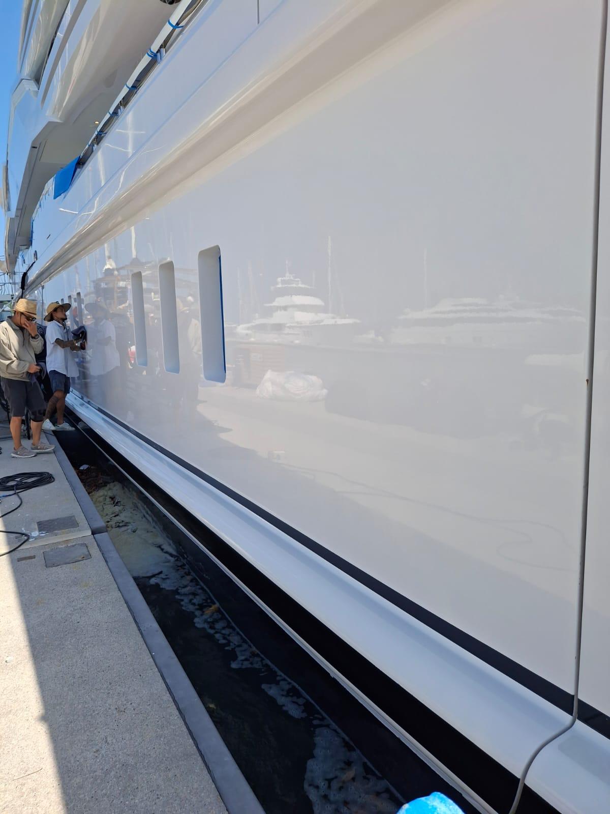 Nano coating project — technician inspecting coated yacht surface