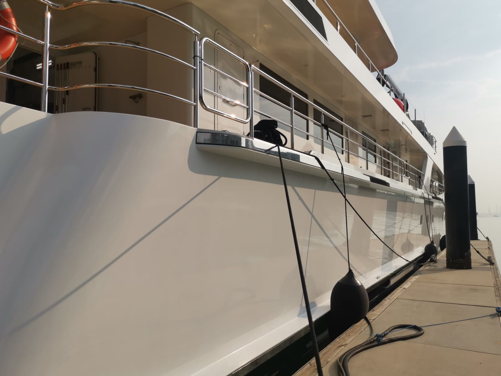 Professional yacht polishing — starboard side high-gloss finish