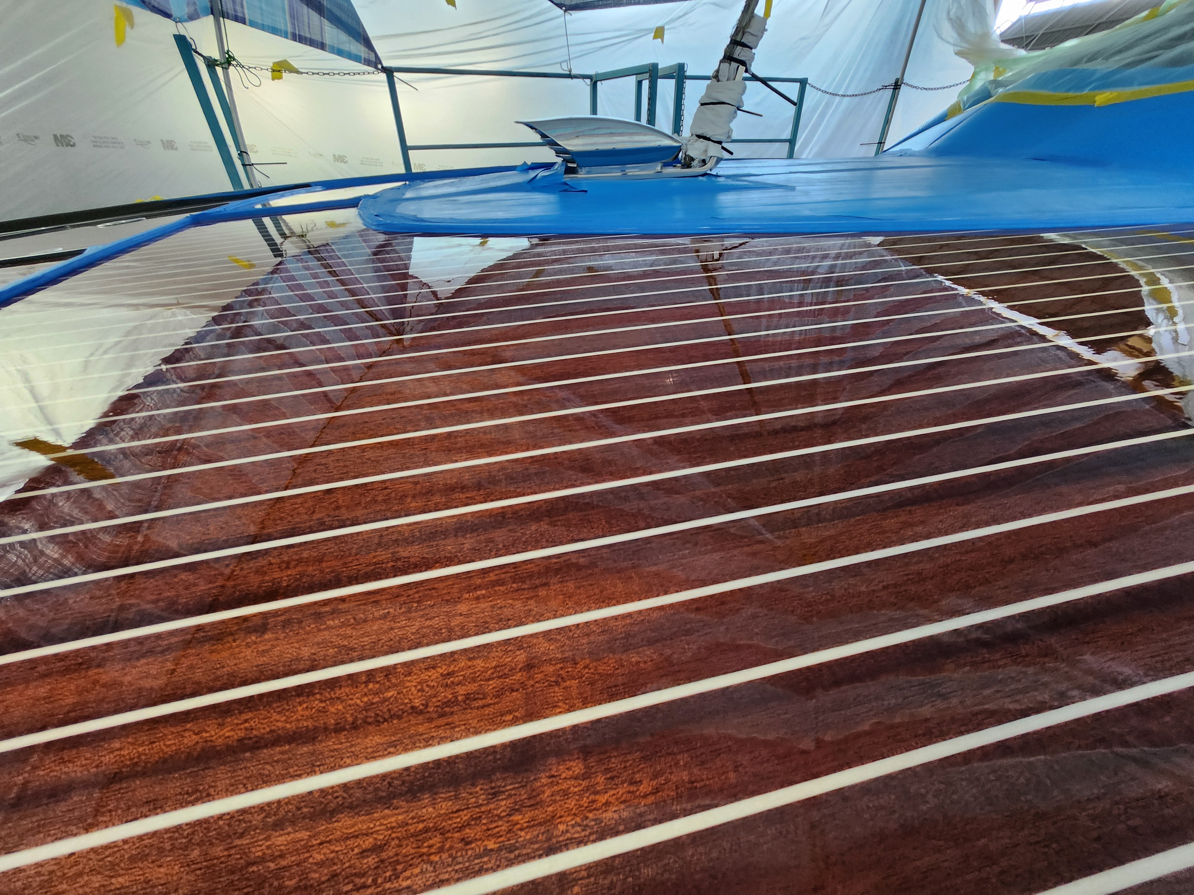 Yacht varnishing — brightwork detail with high-gloss finish