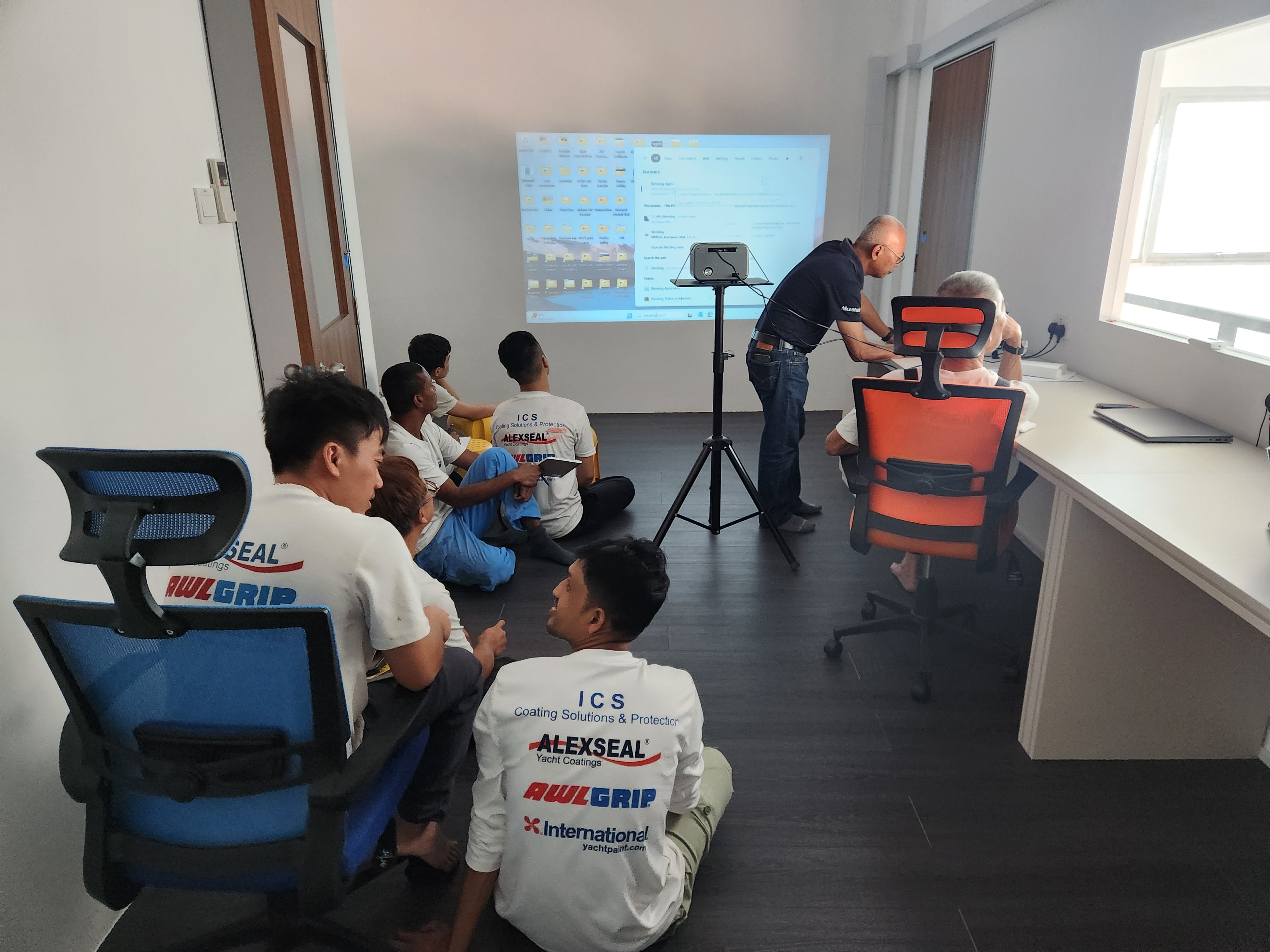 ICS applicators attending a classroom training session on yacht coatings
