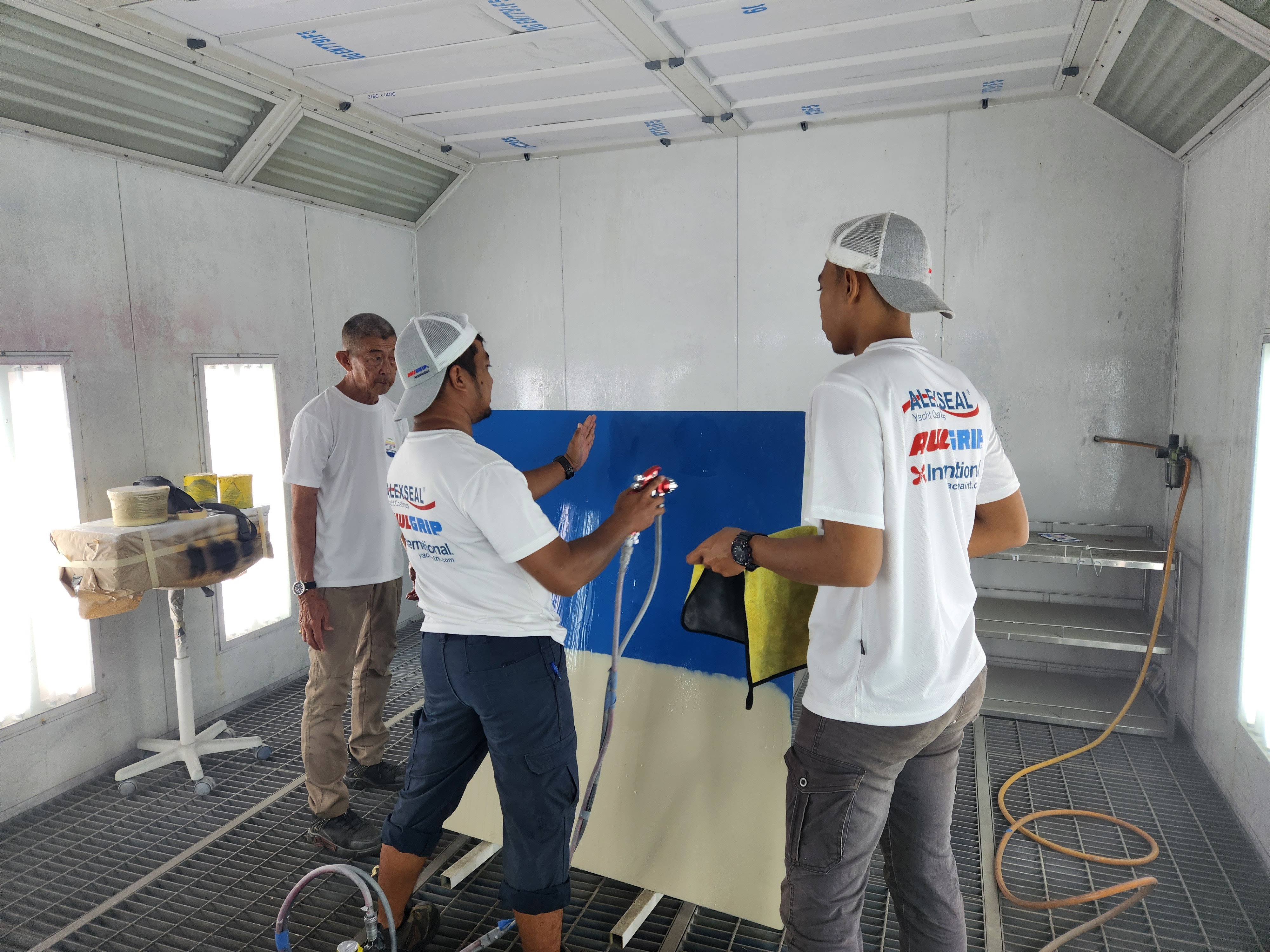 ICS team members collaborating on spray painting practice