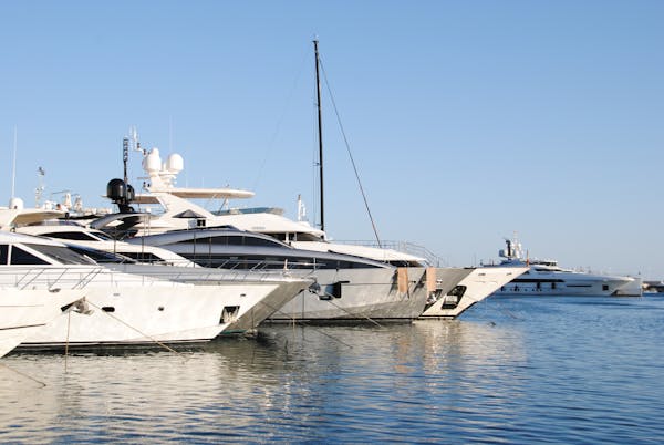 Luxury yachts docked in marina showcasing quality coating results